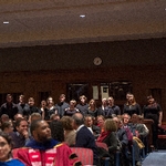 A student choir stands in the audience